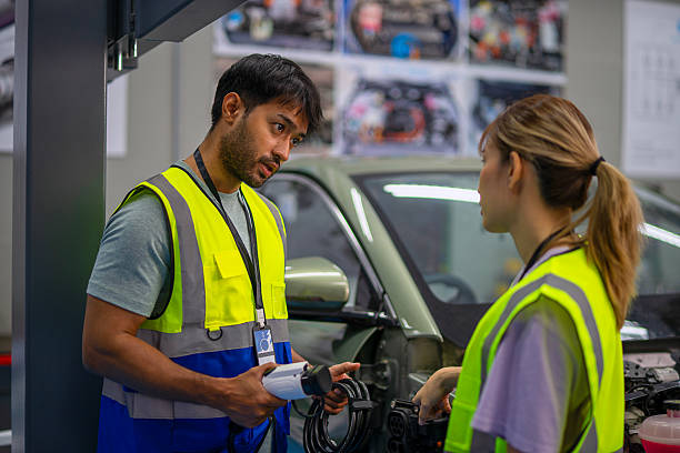 istock Mechanics are working at EV car workshop. 2233312553
