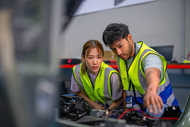 istock Mechanics are working at EV car workshop. 2233312624
