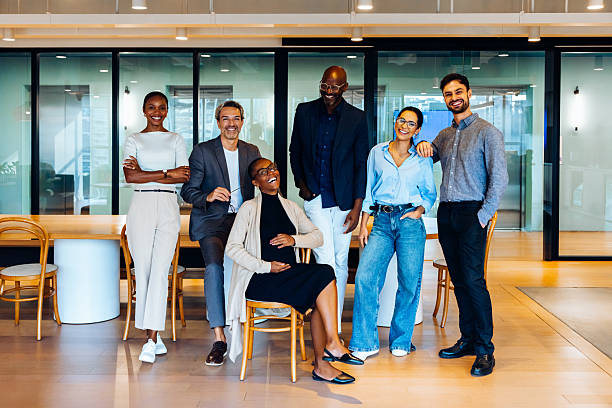istock Diverse group of colleagues smiling and posing in a professional office space 2233313285