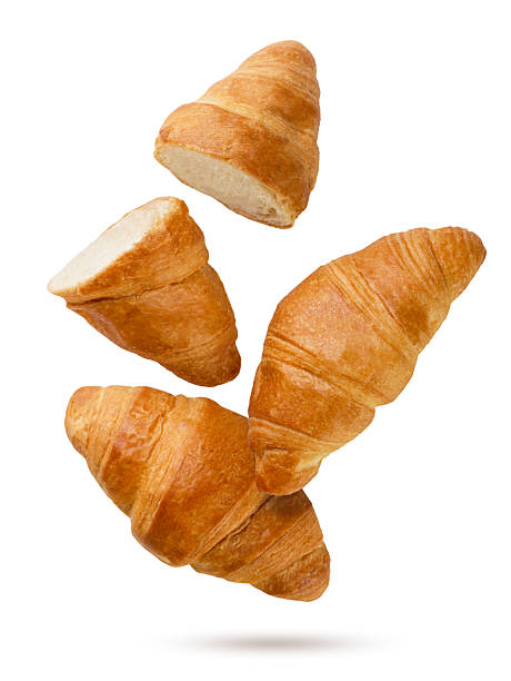 istock Croissants and two halves flying close-up on a white. Isolated 2233313548