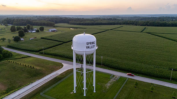 istock Sunset behind water tower in field 2233314268