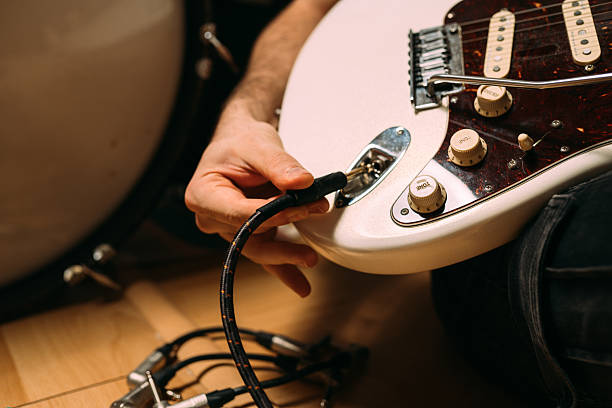 istock Close-up of plugging cable into electric guitar 2233314688