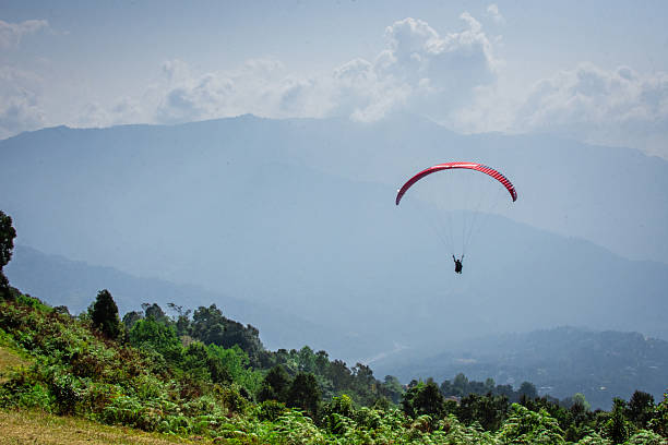 istock Para-glider Soaring Above Scenic Landscape Under Clear Blue Sky 2233320330