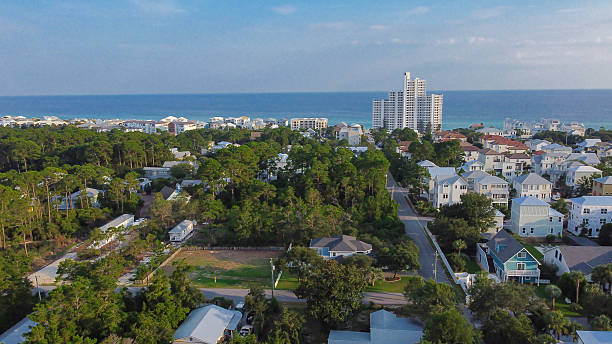 istock Lush forest transitions into scattered homes and dense coastal buildings in Santa Rosa Beach, Walton County. Natural-to-urban shift, highlighting land use and environmental contrast in Florida 2233320749