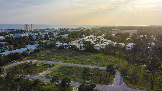 istock Scenic Santa Rosa Beach coastal community with dense white rooftops and ocean backdrop. Foreground shows vacant land, highlighting development potential, urban expansion near shoreline, Florida 2233320753