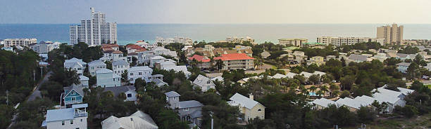 istock Panorama aerial view beachside town with tightly packed white-painted multistory homes, vacation rental. Scenic ocean showcasing tourism-driven density, coastal living appeal near Destin, Florida 2233320777