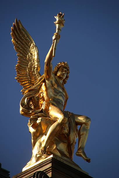 istock Golden Angel Statue Against Blue Sky 2233322101