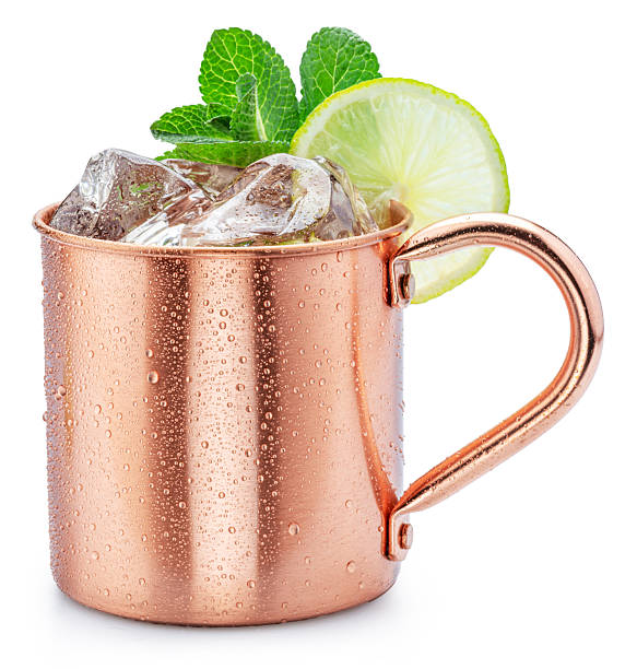 istock Copper cup with Moscow mule drink decorated with lime and mint leaves white background. Clipping path. 2233322820