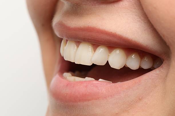 istock Woman smiling with her teeth on white background, closeup 2233323709