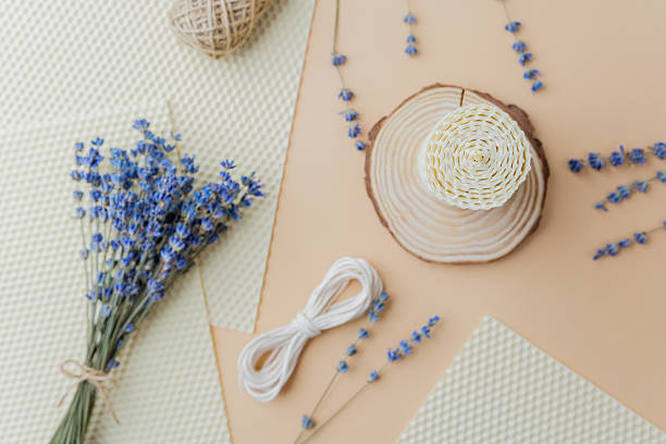 istock Candle making supplies and lavender flowers on beige surface flat lay 2233324394