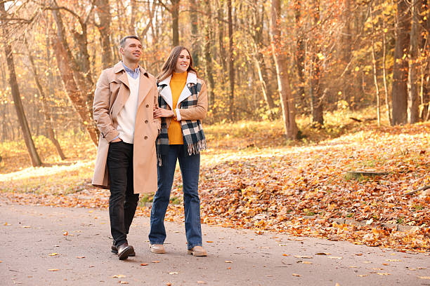 istock Happy couple spending time together in autumn park, space for text 2233326210