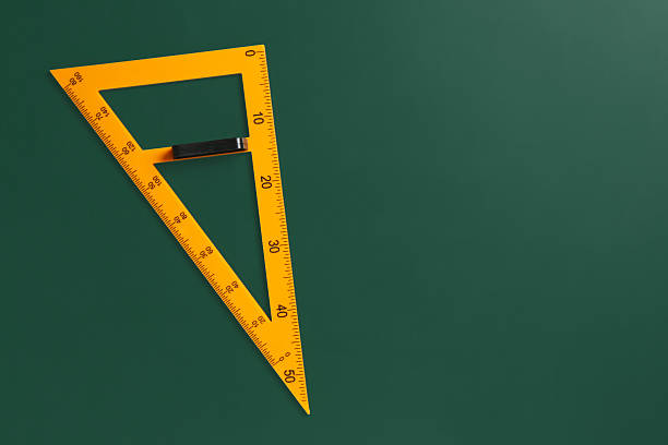 istock One triangle ruler on green chalkboard, top view. Space for text 2233327153
