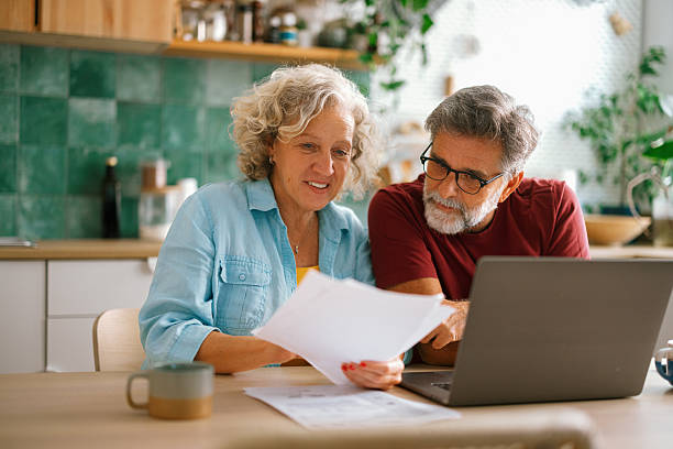 istock Senior couple checking finances and paying bills 2233330523