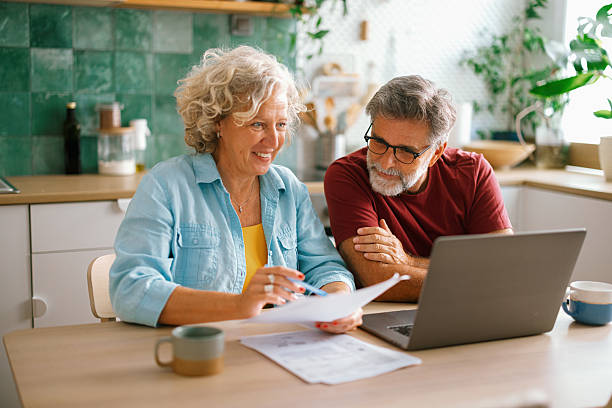 istock Senior couple checking finances and paying bills 2233330534