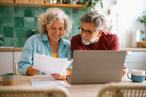 istock Senior couple checking finances and paying bills 2233330578