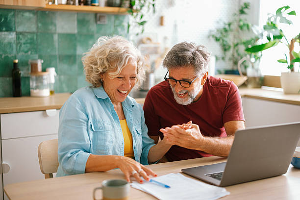 istock Happy couple celebrating loan approval at home 2233330689