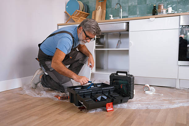 istock Senior handyman plumber fixing kitchen sink at home 2233330854