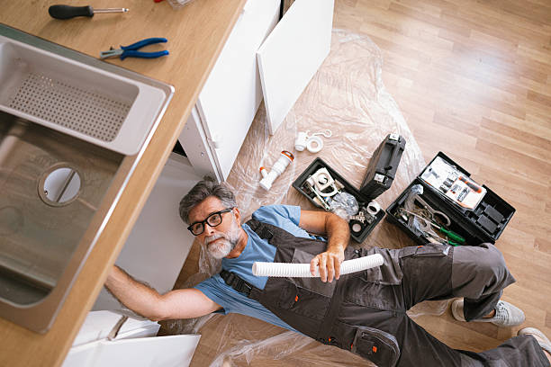istock Senior handyman plumber fixing kitchen sink at home 2233330868