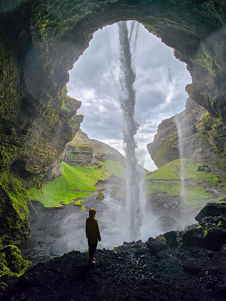 istock Majestic waterfall cascading through a cave with a silhouette in Iceland 2233332954