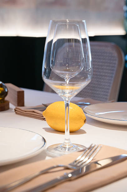 istock An Elegant and Sophisticated Table Setting Featuring a Wine Glass and a Fresh Lemon Slice 2233333278