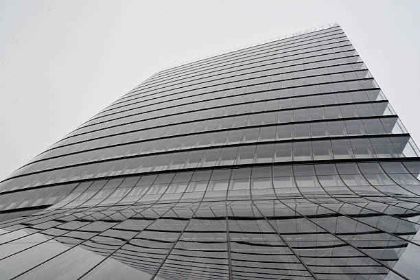 istock Modern Glass Skyscraper with Curved Lines on Overcast Day 2233335281