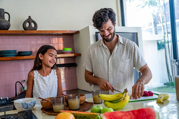 istock Father and Daughter Preparing Healthy Breakfast Together in a Bright, Modern Kitchen 2233336519