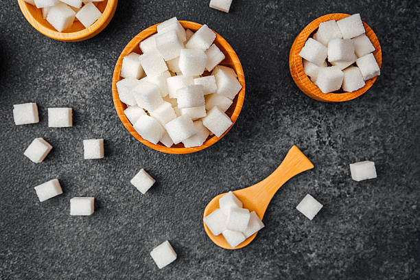 istock White sugar cubes arranged in bowls and scattered on a dark surface 2233336610