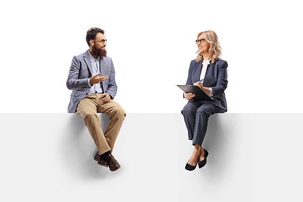 istock Man sitting on a panel and having a conversation with a professional woman 2233337582