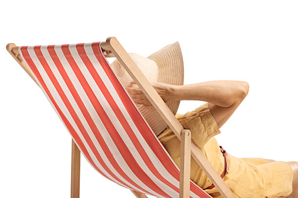 Woman sunbathing on a deck chair isolated on white background