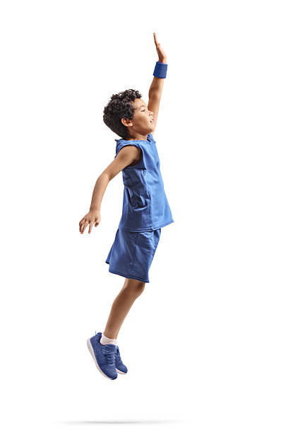 Boy in a blue sports jersey jumping isolated on white background