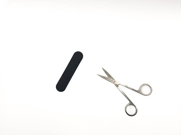 istock A pair of scissors and a nail file are on a white background 2233340105