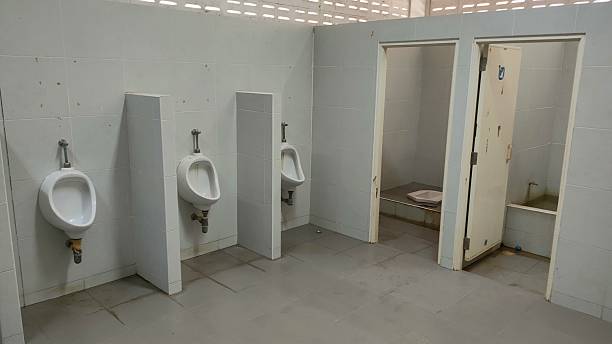 istock A bathroom with three urinals and two doors 2233341145