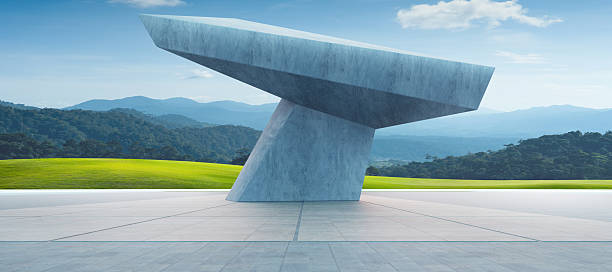 3d rendering of a futuristic concrete structure in a green valley, with mountains and blue sky in the background
