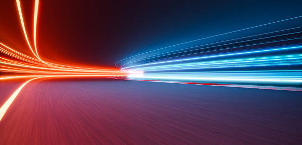 istock 3d rendering light trails crossing on a racetrack at night showing speed and competition 2233342479