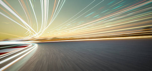 istock 3d rendering speeding on a racetrack with motion blur and light trails at sunset 2233342854