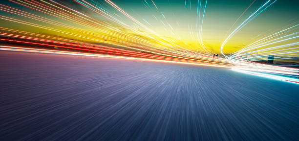 istock 3d rendering light trails and blurred motion on highway at sunset 2233342857