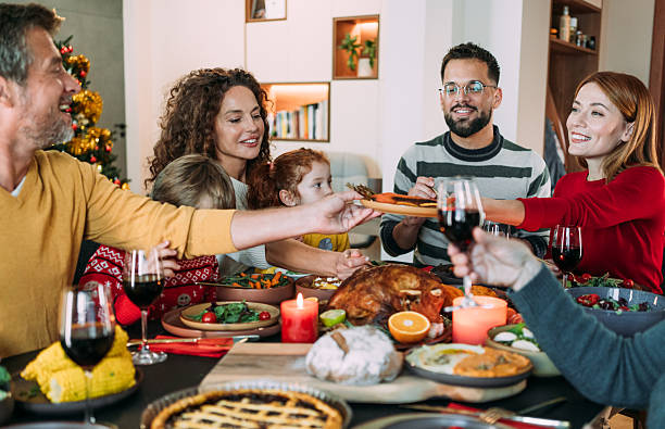 istock Happy extended family celebrating Christmas at dining table. 2233352317