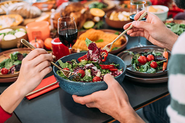 istock Happy extended family celebrating Christmas at dining table. 2233352323