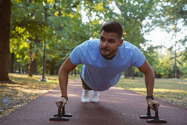 istock Outdoor Calisthenics Workout Using Push-Up Bars in the Park 2233353546
