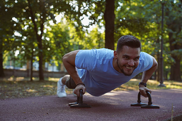 istock Outdoor Calisthenics Workout Using Push-Up Bars in the Park 2233353727
