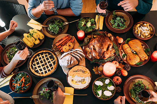 istock Happy family celebrating Thanksgiving at dining table. 2233357612