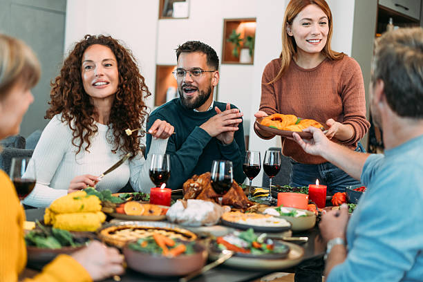 istock Happy extended family celebrating Thanksgiving at dining table. 2233357619
