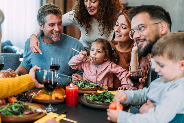 istock Happy extended family celebrating Thanksgiving at dining table. 2233357642