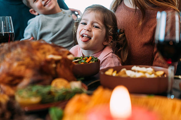 istock Happy extended family celebrating Thanksgiving at dining table. 2233357674