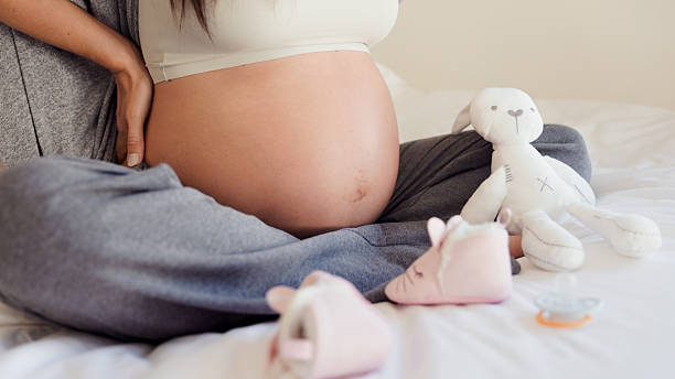 istock Pregnant Woman Stroking Belly, Massaging Back – On Bed 2233358121