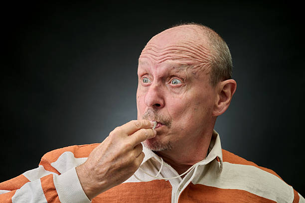 Closeup portrait of a referee blowing a whistle in a vintage Harcourt style lighting