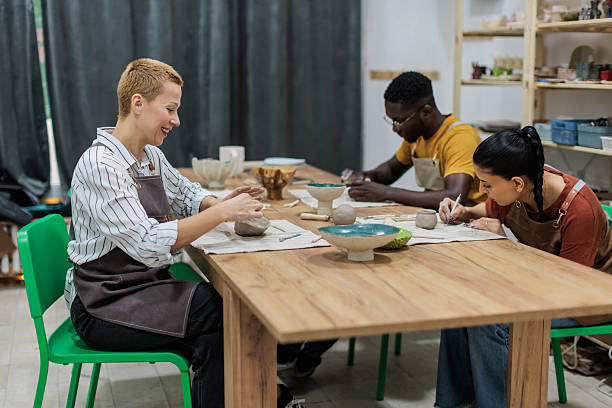 istock Friends enjoying pottery workshop together 2233361056