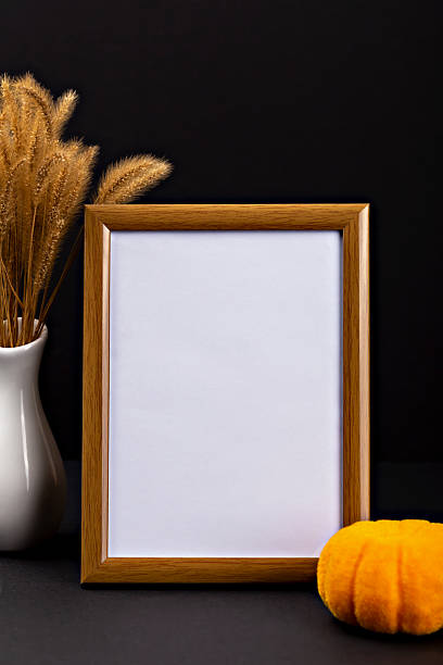 istock Empty wooden frame with white background, decorative pumpkin and dried grass for Halloween theme 2233361573