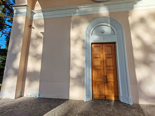istock An elegant neoclassical doorway surrounded by light and shadow interplay. It represents the contrast between openness and restraint, echoing the complexities of human psychology 2233362797