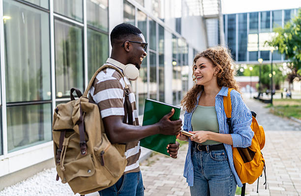 istock Cheerful university or college students talking outdoors 2233363044